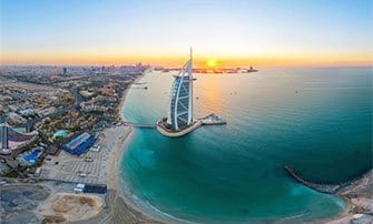 The Burj Al Arab and Dubai coastline at sunrise, a potential MSC Cruises destination | MSC Cruises The Burj Al Arab and Dubai coastline at sunrise, a potential MSC Cruises destination | MSC Cruises