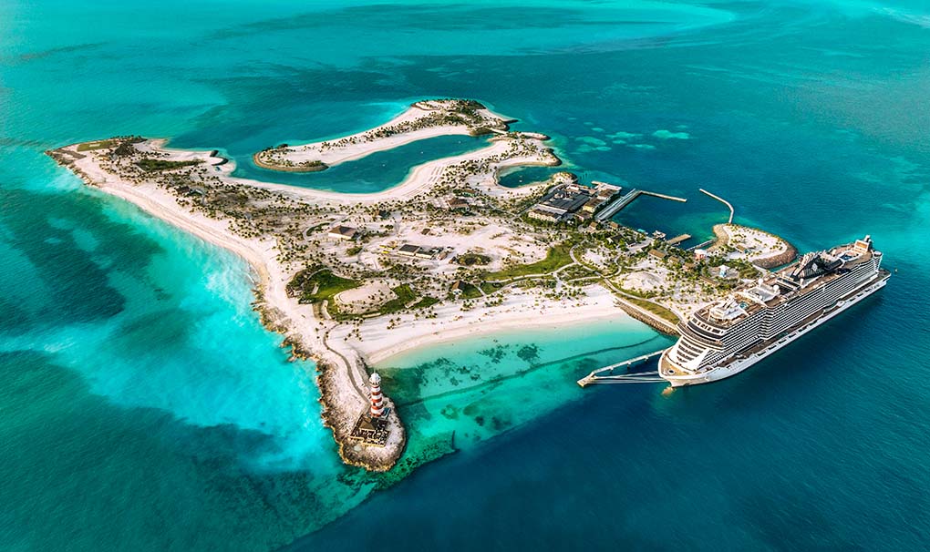 Aerial view of a cruise ship docked at a tropical private island with turquoise waters | MSC Cruises