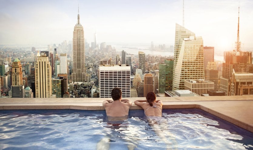 Couple relaxing in an infinity pool overlooking the New York City skyline | MSC Cruises Couple relaxing in an infinity pool overlooking the New York City skyline | MSC Cruises
