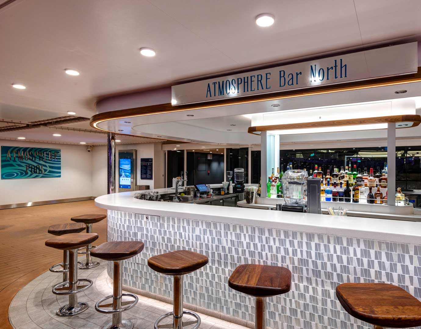 Atmosphere Bar North with wooden stools and a well-stocked counter on an MSC Cruises ship | MSC Cruises Atmosphere Bar North with wooden stools and a well-stocked counter on an MSC Cruises ship | MSC Cruises